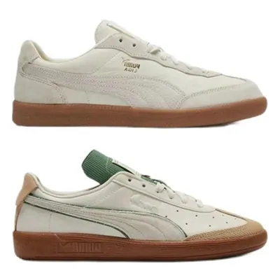 Two low-top suede trainers in cream, stacked one above the other on a plain white background, both on gum rubber soles.