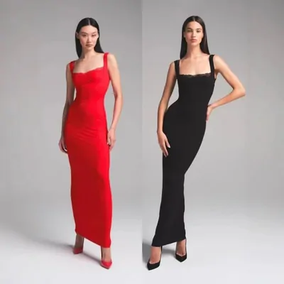 Two models on a plain grey background wearing floor-length slip dresses, one red and one black.